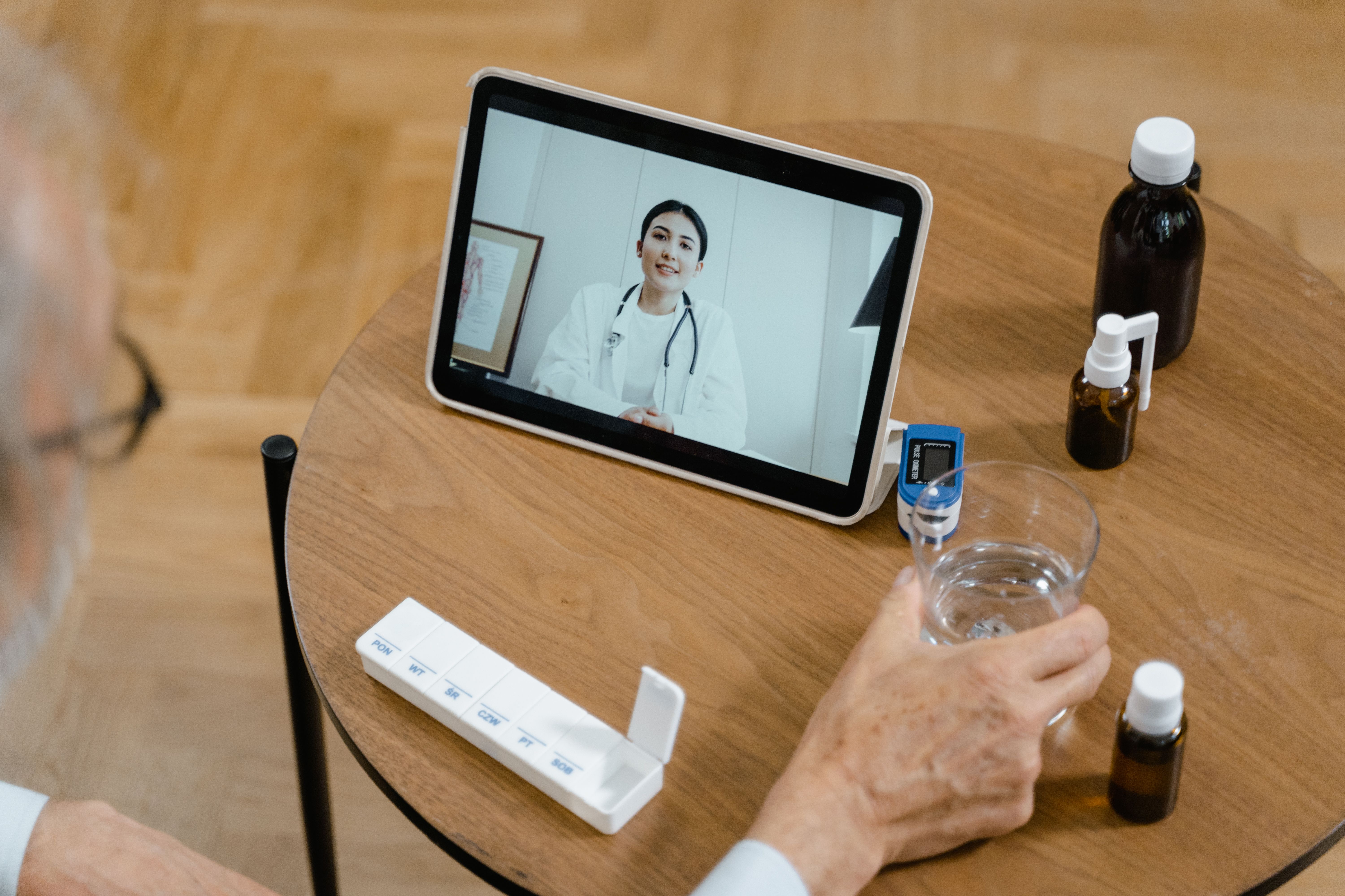 A nurse practitioner on a virtual visit with a senior patient.